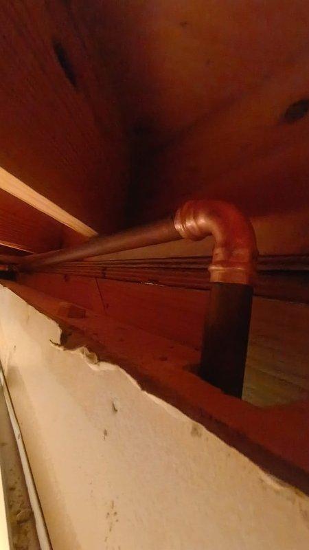 Returned to address recurring leak at exterior hose bib that was previously serviced. Inspected copper piping and connections in basement utility area where the hose bib line runs through wooden framing. Identified source of continued water seepage at the pipe joint and elbow connection. Repaired the leaking hose bib assembly, secured copper piping with proper brackets, and verified all connections were watertight with no active leaks upon completion.