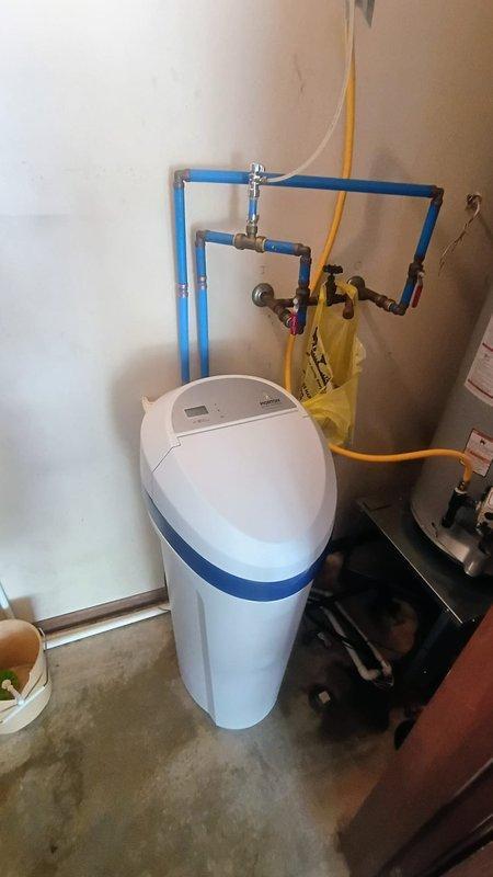 Nappanee, IN - Completed installation of new water softener system in utility room, including connection of blue PVC supply and return piping with proper loop configuration and metal fittings. Integrated existing gas line connections with brass valves and installed all necessary clamps and securing hardware. Additionally installed new outdoor water spigot as requested, providing exterior access to water supply.