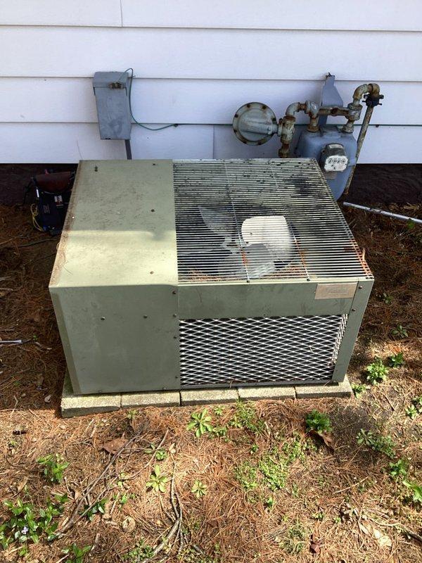 # HVAC Maintenance - Planned Single Maintenance

Completed comprehensive air conditioning maintenance on outdoor condensing unit. Upon arrival, discovered significant accumulation of organic debris including dried grass, leaves, and nesting material within the unit housing that was obstructing airflow and surrounding refrigerant lines. Removed all debris from interior compartment and cleaned around copper tubing and electrical components. Inspected capacitor, contactor, and all electrical connections for proper operation. Verified refrigerant lines, service valves, and connections showed no signs of active leakage. Cleaned condenser coil fins and fan assembly. Unit restored to proper operating condition with improved airflow and system efficiency.
