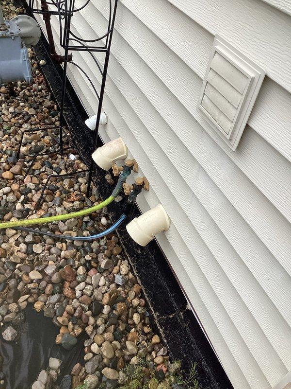 Responded to report of slow drip water leak in basement area related to HVAC condensate drainage system. Upon arrival, inspected exterior condensate drain lines and discovered improper drainage from PVC discharge pipes at foundation level. Condensate lines were discharging too close to foundation, causing water infiltration into basement. Verified proper operation of condensate pump and primary drain line. Redirected condensate discharge away from foundation using existing hose connection to prevent further water intrusion. Advised homeowner on proper condensate line maintenance and monitoring for future leaks.