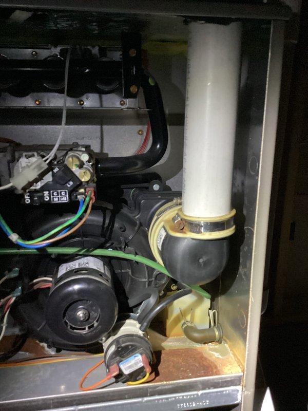 # HVAC Membership Maintenance Completed

Performed comprehensive planned maintenance on residential HVAC system including both air conditioning and furnace components per membership agreement. Accessed air handler unit and conducted thorough inspection of blower motor assembly, electrical connections, and internal components. Verified all wiring connections at terminal blocks were secure with no signs of overheating or deterioration. Inspected condensate drain piping and support brackets for proper alignment and function.

Examined blower motor operation and associated electrical components including capacitor and control wiring. Noted normal dust accumulation on base panel and internal surfaces consistent with system operation. All electrical connections including multi-colored control wiring showed proper termination and secure attachment points. Verified proper mounting and operation of motor assembly and blower wheel.

Photographed internal components documenting current system con