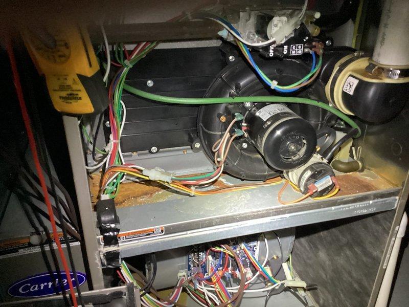# HVAC Membership Maintenance Completed

Performed comprehensive planned maintenance on residential HVAC system including both air conditioning and furnace components per membership agreement. Accessed air handler unit and conducted thorough inspection of blower motor assembly, electrical connections, and internal components. Verified all wiring connections at terminal blocks were secure with no signs of overheating or deterioration. Inspected condensate drain piping and support brackets for proper alignment and function.

Examined blower motor operation and associated electrical components including capacitor and control wiring. Noted normal dust accumulation on base panel and internal surfaces consistent with system operation. All electrical connections including multi-colored control wiring showed proper termination and secure attachment points. Verified proper mounting and operation of motor assembly and blower wheel.

Photographed internal components documenting current system con