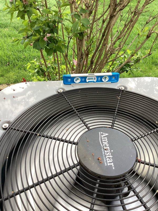 Completed planned dual-system air conditioning maintenance on two Ameristar condenser units as part of membership service. Performed comprehensive inspection of both outdoor units including verification of level positioning, cleaning of debris from top surfaces and surrounding areas, inspection of fan assemblies and protective grilles, and assessment of cabinet condition and electrical connections. Both systems were found to be in operational condition with proper levelness confirmed on primary unit.