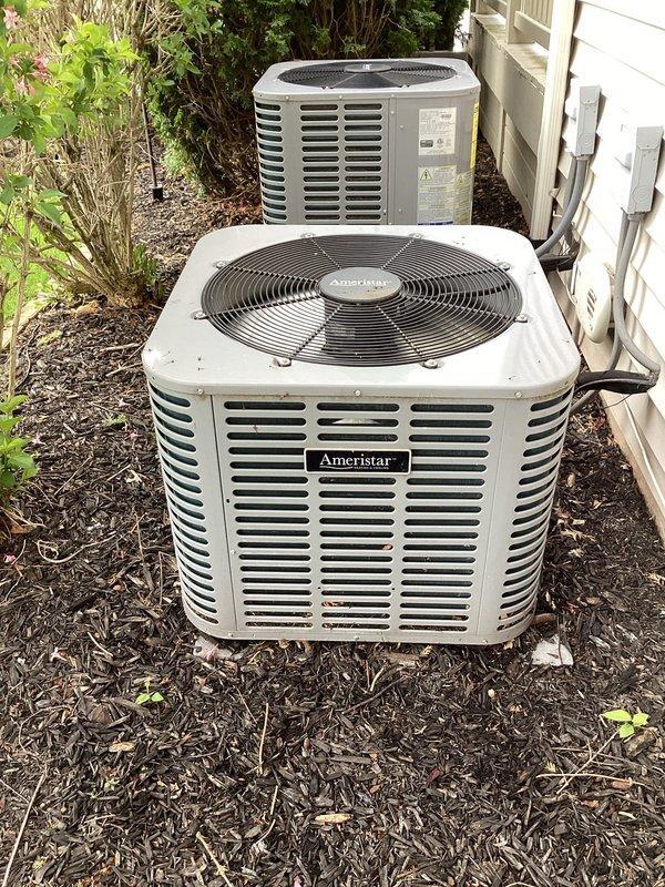 Completed planned dual-system air conditioning maintenance on two Ameristar condenser units as part of membership service. Performed comprehensive inspection of both outdoor units including verification of level positioning, cleaning of debris from top surfaces and surrounding areas, inspection of fan assemblies and protective grilles, and assessment of cabinet condition and electrical connections. Both systems were found to be in operational condition with proper levelness confirmed on primary unit.