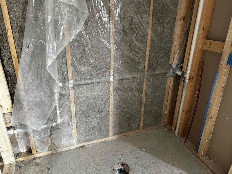 Conducted on-site assessment for plumbing estimate regarding steam shower installation and general replumbing requirements. Inspected exposed wall structures with existing insulation, vapor barriers, and current PVC drain/vent pipe configuration. Evaluated rough-in plumbing needs and identified necessary modifications to accommodate requested steam shower installation.