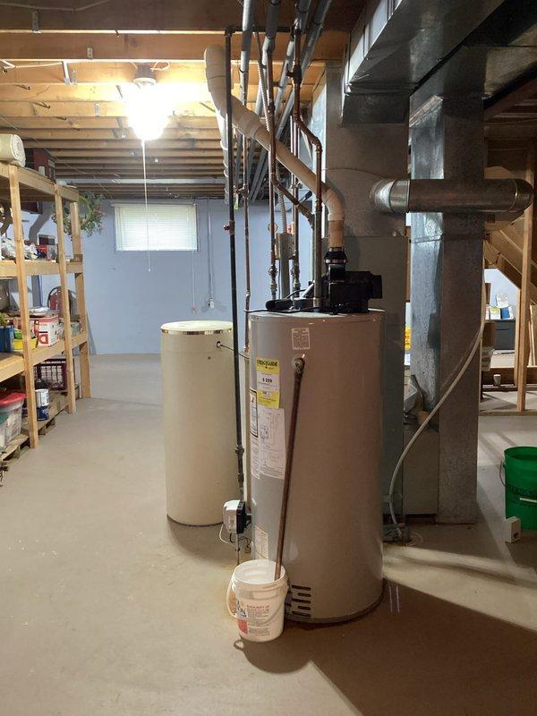 Elkhart, IN - Conducted inspection of existing water heating system in basement utility area, including primary tan/beige water heater and secondary white unit. Client confirmed preference for tank-style replacement. Scheduled follow-up appointment for January 16th with possibility of earlier installation if availability permits.