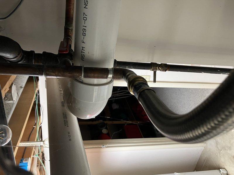 Installed a new 50-gallon Whirlpool draft vent water heater with expansion tank in utility area. Completed all necessary copper and PVC pipe connections, ensuring proper fittings and valve installations. System was tested and confirmed to be functioning correctly with no leaks observed.