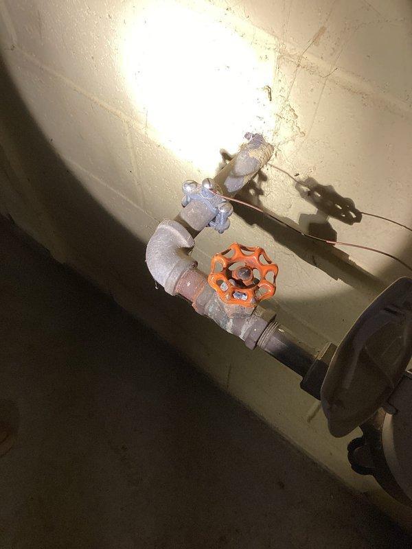 Responded to customer concern regarding copper pipe leak in water softener supply line. Visual inspection confirmed leak point in the plumbing assembly with orange valve handle. Replaced damaged section of copper pipe and restored proper water flow to softener system.