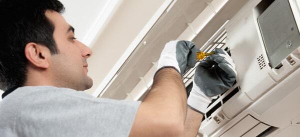 HVAC technician working on a ductless AC