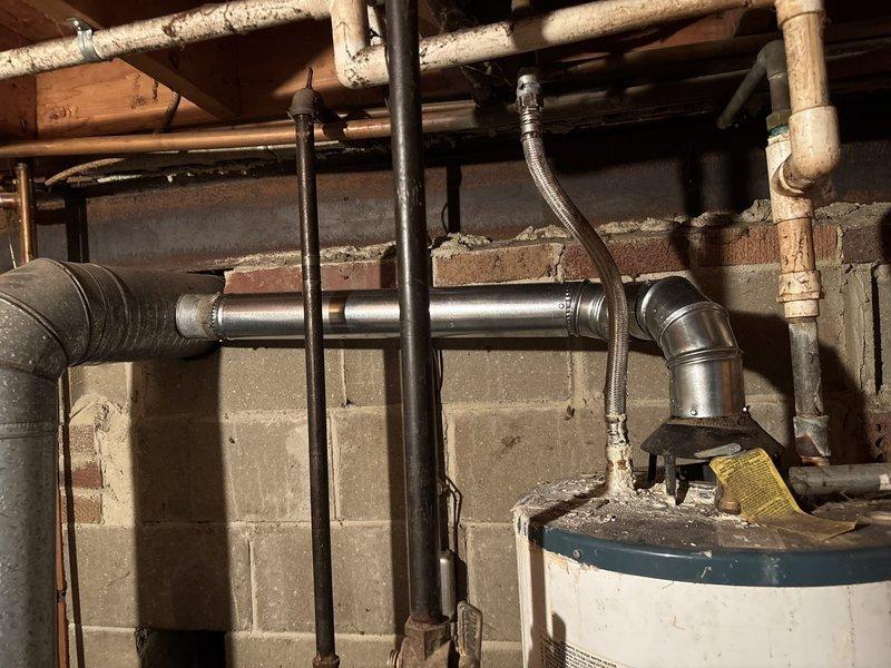 Performed comprehensive maintenance on aging furnace system including thorough cleaning of burners and burner box, adjustment of burners for optimal performance, and repair of compromised venting components. System testing revealed proper gas pressure readings after service, with all heating functionality restored to normal operation.