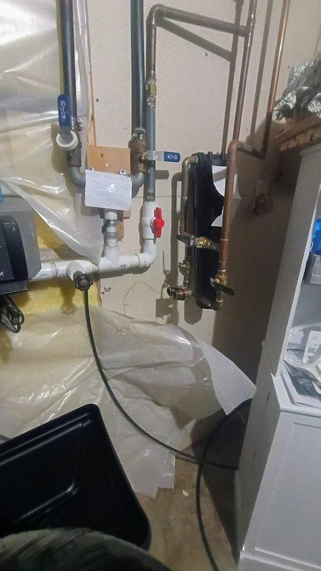 Edwardsburg, MI - Conducted on-site assessment for water softener installation where customer has already purchased the unit. Existing plumbing infrastructure is in place from previous water softener, including copper and PVC pipes with accessible shutoff valves. Evaluated current configuration and confirmed compatibility with new unit without need for significant modifications.