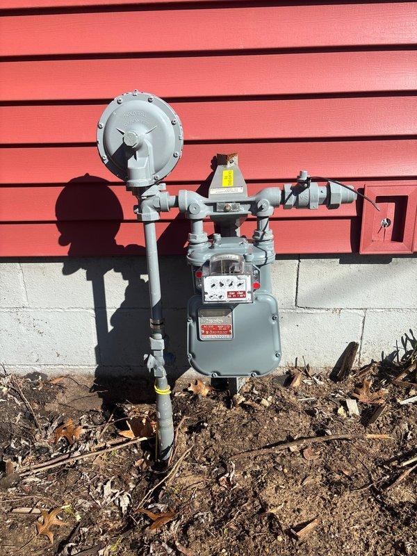 Niles, MI - Responded to service call for gas leak investigation per MJC request. Met with gas company representative at property (door code: 0225) and conducted comprehensive inspection of exterior gas meter installation. Visual inspection revealed properly mounted meter with intact pressure regulator and no apparent leaks at connection points. Documentation completed with photographic evidence of gas meter assembly for service records.