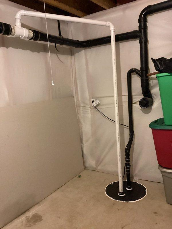 South Bend, IN - Replaced existing sump pit lid with a sealed lid and installed a new vent pipe to properly ventilate the sump pump system and prevent potential radon gas buildup or odor issues. The new PVC vent piping was routed vertically and integrated with the existing discharge piping to ensure proper system operation and code compliance.
