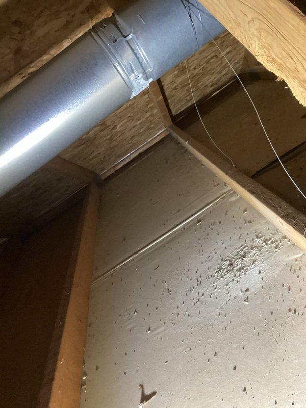 Responded to warranty call to assess improperly installed furnace venting system from previous installation approximately five years ago. Upon inspection, discovered that a 3" furnace vent had been incorrectly routed into a 6" common vent with the water heater without proper liner installation, resulting in significant corrosion and moisture leaking. Documented existing conditions with photographs showing corroded ductwork with visible moisture accumulation, substantial debris buildup within the vent system, and deteriorated metal surfaces with oxidation. Evaluated the improper venting configuration and provided assessment of necessary repairs to bring system into compliance with proper venting standards.