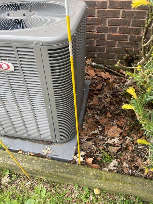 Responded to service call for Lennox outdoor condensing unit that was physically displaced after being struck by fire truck equipment. Upon arrival, found unit had been moved off its original position on concrete pad. Inspected unit for structural damage, refrigerant line integrity, electrical connections, and proper leveling. Repositioned condensing unit on pad using temporary support stakes to ensure proper drainage and airflow clearance from building structure. Verified electrical disconnect box connections remained secure and undamaged. Unit operational at time of service with no immediate refrigerant leaks detected or electrical issues observed.
