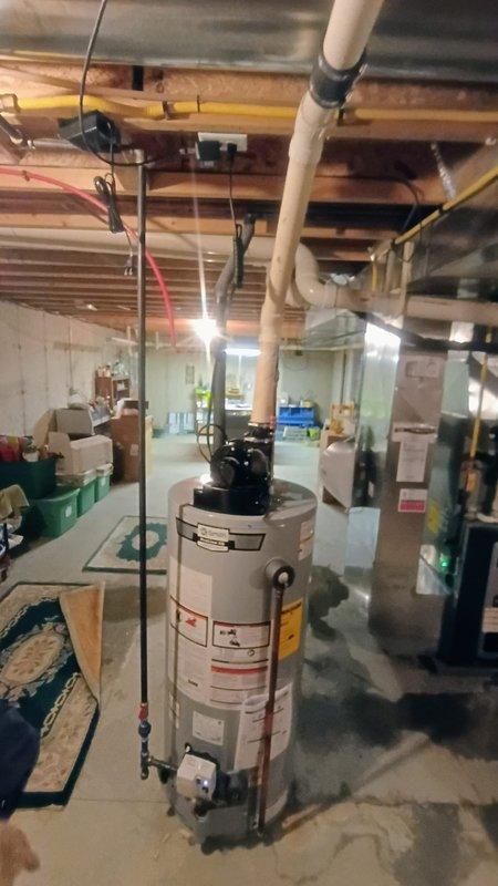 Bristol, IN - Successfully replaced aging 20+ year old leaking water heater with new 40-gallon power vent unit in unfinished basement. Installation completed with proper venting and connections to existing plumbing system. Customer received manufacturer documentation and operational instructions for the new unit.