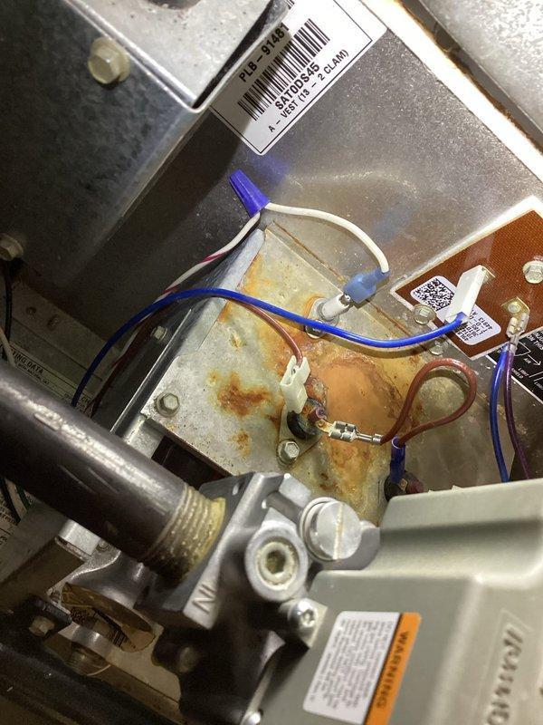 Diagnosed 16-year-old HVAC system that was running intermittently and blowing cold air. Inspection revealed significant corrosion and rust on critical components including the heat exchanger and electrical connections. Determined system failure due to age-related deterioration of metal surfaces and compromised electrical terminals. Recommended replacement of system due to safety concerns and efficiency issues.