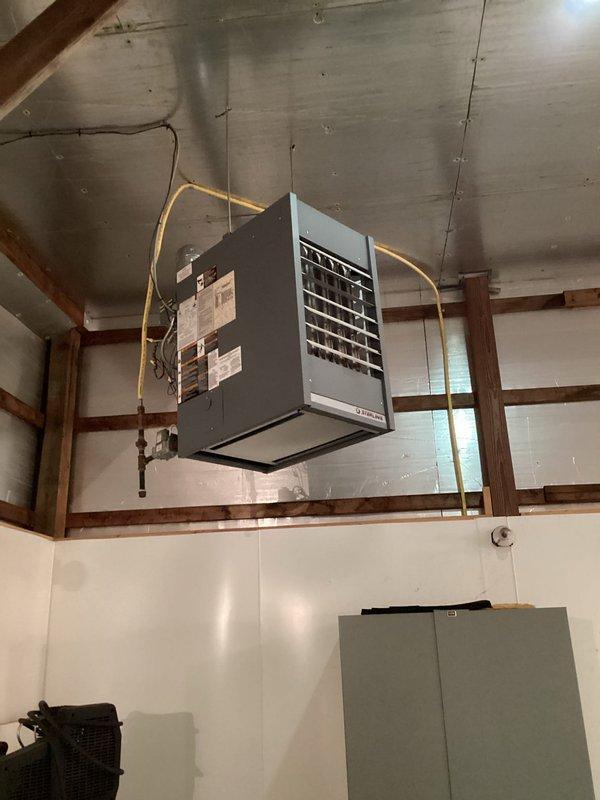 Warsaw, IN - Responded to no-heat call at commercial airport hangar where suspended ceiling-mounted gas heating unit was non-operational, resulting in ice formation inside the facility. Diagnosed ignition failure and replaced faulty control board, cleaned flame sensor, and verified proper gas supply. System is now functioning properly with consistent heat output and normal operation confirmed through multiple test cycles.