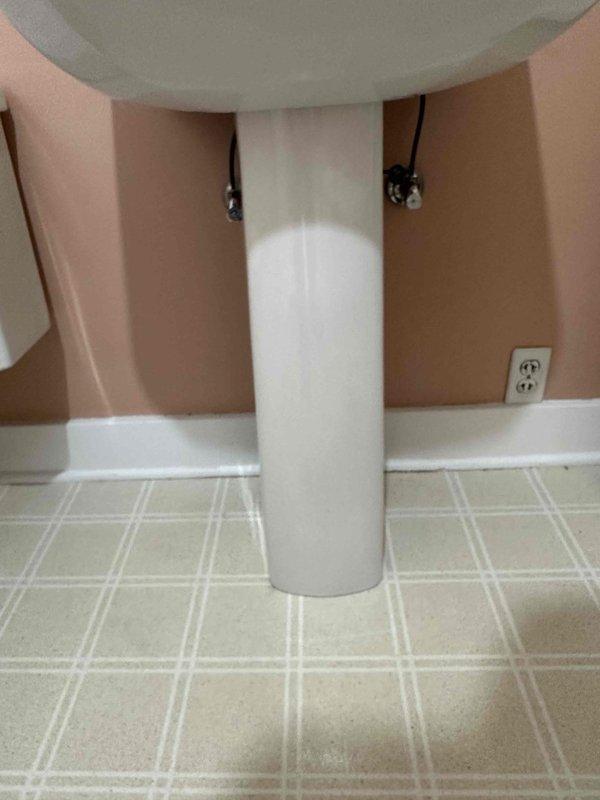 Picked up and installed new pedestal sink and chrome single-handle faucet. Connected water supply lines and ensured proper drainage. Noted existing wall damage behind sink where drywall is deteriorating along the backsplash area.