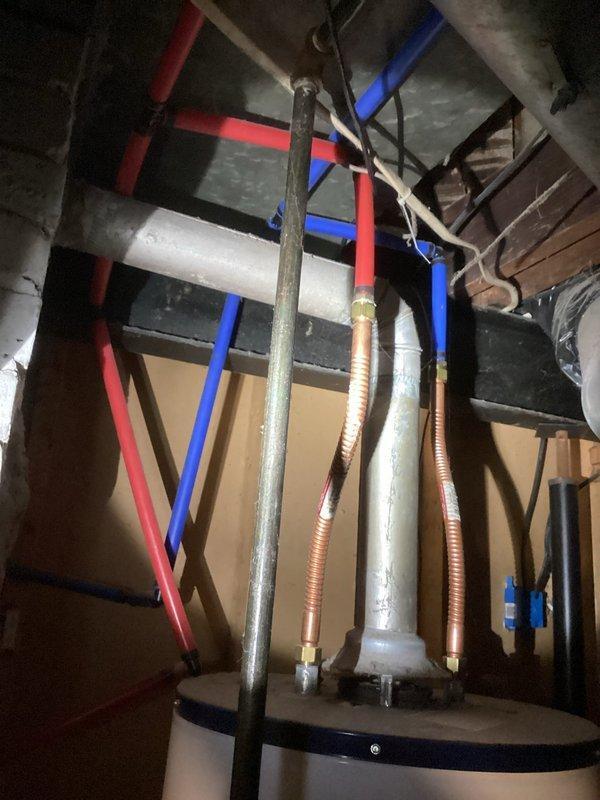 Responded to service call for a tanked water heater with non-functioning pilot light. Upon inspection, found significant corrosion and rust around the connection points and control area. Diagnosed failed thermocouple and gas valve issues requiring complete unit replacement as previously estimated due to age and deterioration of the existing system.
