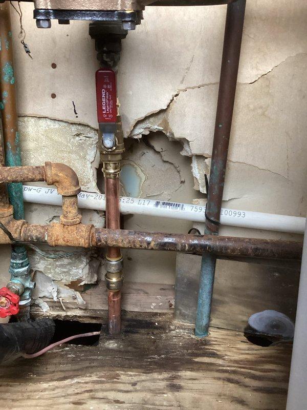 South Bend, IN - Completed return service call to address previously unfinished plumbing connection. Successfully connected and pressure tested supply line with Legend valve assembly, integrating existing copper piping with new PVC components. Wall damage around installation area was noted but not addressed as it falls outside scope of plumbing services.