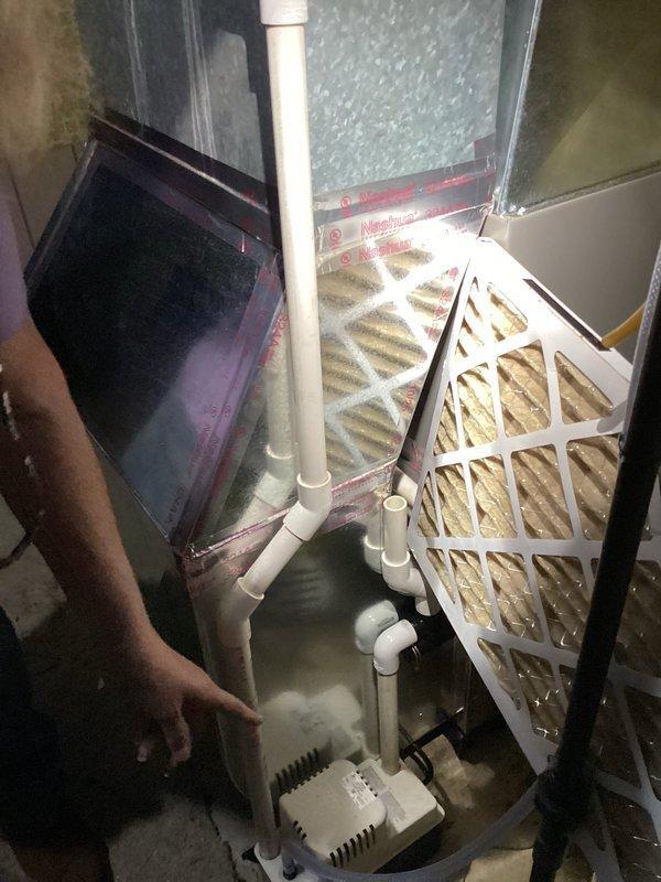 Goshen, IN - Responded to service call regarding customer difficulty removing air filter and concern about loose piping. Upon inspection, accessed HVAC system and demonstrated proper filter removal/replacement technique. Inspected and secured condensate drain line connections that had become loose, ensuring proper alignment and sealing of all PVC pipe joints in the drain system. System now operating correctly with all components properly secured.