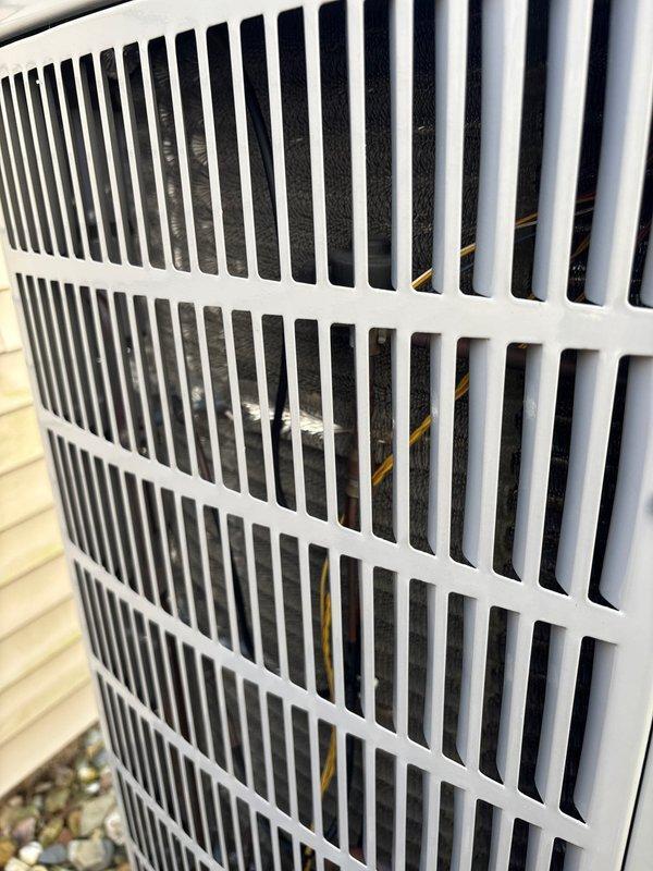 Performed scheduled maintenance on residential A/C unit with customer-supplied filters (20x20x4). Inspected outdoor condenser unit, confirming proper ventilation through grille and examining coil condition. Maintenance plan expires 4/26.
