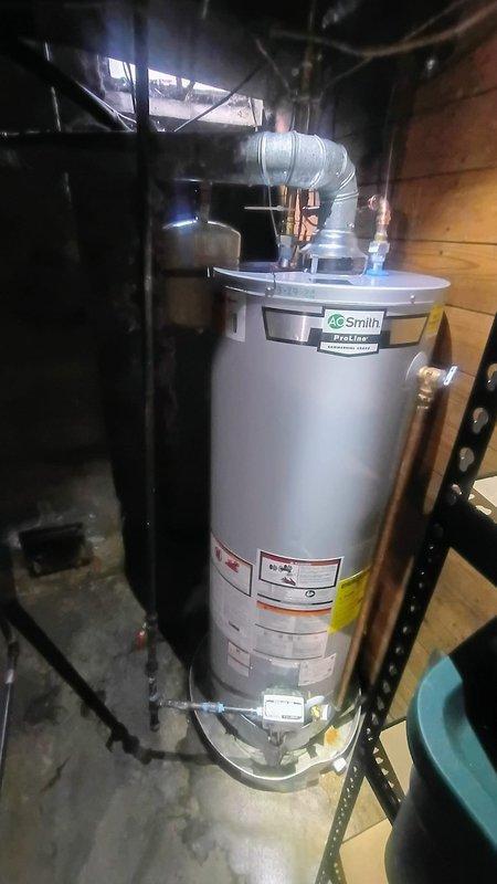 Responded to service call for 12-year-old water heater with pilot light failure and minor water leakage at base. Removed and disposed of failed unit, then installed new A.O. Smith tanked water heater with proper venting and connections to existing plumbing infrastructure. Tested all connections for leaks, verified proper combustion and pilot operation, and confirmed system functionality before completing installation.