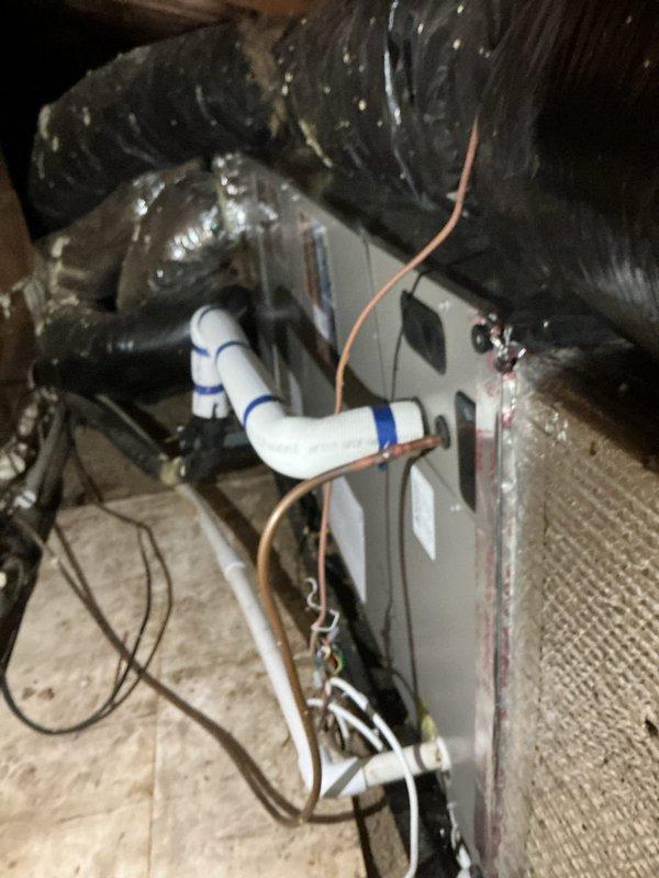 Completed full HVAC system installation including Lennox CBK45UHVT-036-71 air handler mounted in attic space on plywood platform, ML13KC1-036 condensing unit positioned on exterior concrete pad, and T4 Pro programmable thermostat. Installed condensate drain pan with water alarm for overflow protection, routed PVC drain lines with proper pitch, and ran copper refrigerant lines connecting indoor and outdoor units. Completed electrical connections including disconnect box mounted to exterior wall, verified proper voltage and amperage, and tested all system components for proper operation. System commissioned and operational upon completion.