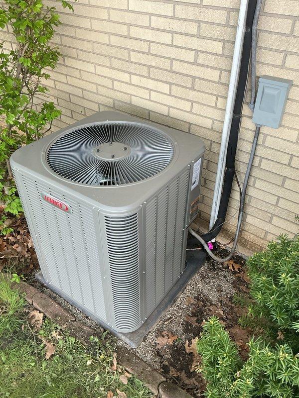 Completed full HVAC system installation including Lennox CBK45UHVT-036-71 air handler mounted in attic space on plywood platform, ML13KC1-036 condensing unit positioned on exterior concrete pad, and T4 Pro programmable thermostat. Installed condensate drain pan with water alarm for overflow protection, routed PVC drain lines with proper pitch, and ran copper refrigerant lines connecting indoor and outdoor units. Completed electrical connections including disconnect box mounted to exterior wall, verified proper voltage and amperage, and tested all system components for proper operation. System commissioned and operational upon completion.